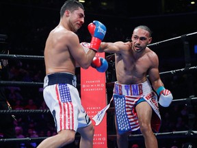 Keith Thurman, right, punches Josesito Lopez during the eighth round of a welterweight championship boxing match Saturday, Jan. 26, 2019, in New York.