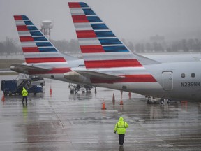 An American Airlines ground staff member walks towards planes on the tarmac at Ronald Reagan Washington National Airport in Arlington, Virginia on Thursday, Jan. 24, 2019.