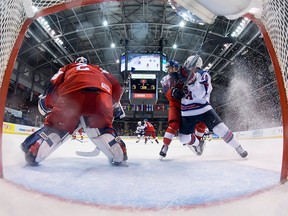 Czech Republic's Jan Hladonik tries to clear United States' Jack Drury from in front of Czech Republic goalie Lukas Dostal during second period IIHF world junior quarterfinal hockey action in Victoria, Wednesday, Jan. 2, 2019.