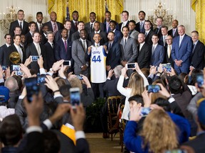 In this Feb. 4, 2016, file photo, President Barack Obama holds up Golden State Warrior basketball jersey given to him by team members during a ceremony in the East Room of the White House in Washington. (AP Photo/Pablo Martinez Monsivais, File)