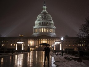 Snow falls on the Capitol as the partial government shutdown continues in Washington, Thursday night, Jan. 17, 2019. (AP Photo/J. Scott Applewhite)