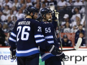 Winnipeg Jets captain Blake Wheeler (left) and centre Mark Scheifele hatch a plan against the Vegas Golden Knights during Game 5 of the Western Conference final in Winnipeg on Sun., May 20, 2018.