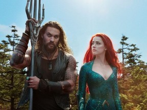 This image released by Warner Bros. Pictures shows Jason Momoa, left, and Amber Heard in a scene from "Aquaman."