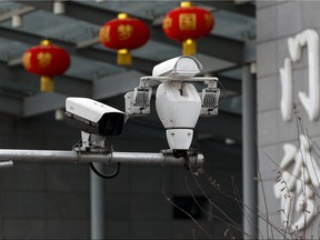 Surveillance cameras is mounted outside a hospital in Beijing, Sunday, Feb. 24, 2019. (AP Photo/Andy Wong)