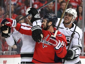 Kyle Clifford #13 of the Los Angeles Kings and Tom Wilson #43 of the Washington Capitals push after a play during the first period at Capital One Arena on February 11, 2019 in Washington, DC.