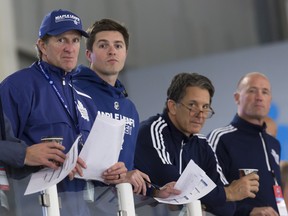 Toronto Maple Leafs head coach Mike Babcock (left) and GM Kyle Dubas (second from left) need to work together on trade deadline day. (THE CANADIAN PRESS)