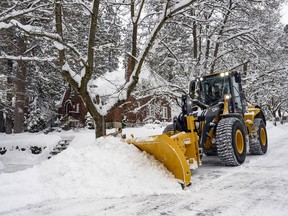A city plow clears snow from Monroe Street at 22nd Avenue, Tuesday, Feb 12, 2019 in Spokane, Wash (Colin Mulvany/The Spokesman-Review via AP)