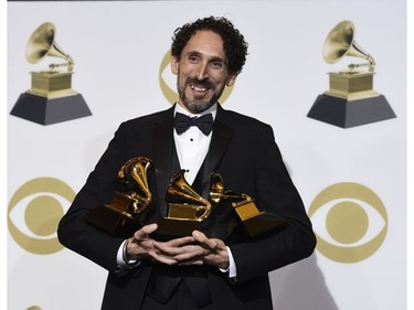 John Daversa poses in the press room with the awards for best improvised jazz solo for "Don't Fence Me In," best large jazz ensemble album for "American Dreamers: Voices of Hope, Music of Freedom" and best arrangement, instrumental or a cappella for "Stars and Stripes Forever" at the 61st annual Grammy Awards at the Staples Center on Sunday, Feb. 10, 2019, in Los Angeles.