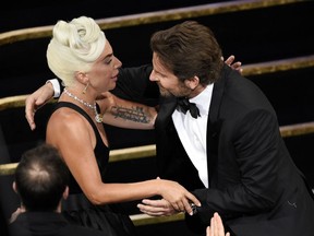 Bradley Cooper, right, congratulates Lady Gaga in the audience after she is announced winner for best original song for "Shallow" from "A Star Is Born" at the Oscars on Sunday, Feb. 24, 2019, at the Dolby Theatre in Los Angeles.