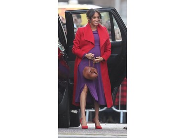 Meghan Markle wears a a vibrant purple dress from Babaton by Aritizia  and a bold red coat by Sentaler for her visit the town of Birkenhead, England, Jan. 14, 2019. (John Rainford/WENN.com)