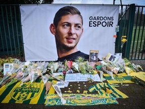A picture shows flowers put in front of the entrance of the training center La Joneliere in La Chapelle-sur-Erdre on January 25, 2019, four days after the plane of Argentinian forward Emiliano Sala vanished during a flight from Nantes, western France, to Cardiff in Wales.
