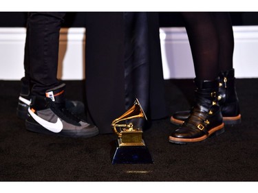 Toni Cornell (R), Christopher Cornell (L) and their mother Vicky pose in the press room as they accept the Grammy, posthumously,  for their father/ husband, Chris Cornell and the Best Rock Performance "When Bad Does Good" during the 61st Annual Grammy Awards on February 10, 2019, in Los Angeles.