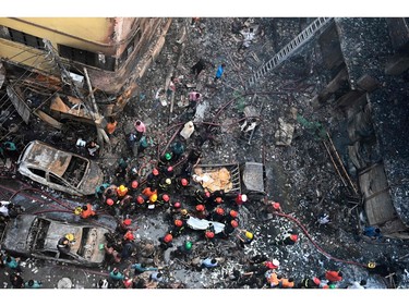 Rescue personnel carry the body of a victim after a fire broke out in Dhaka on Feb. 21, 2019.