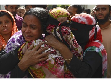Relatives of victims mourn after a fire tore through apartment blocks mourn in Bangladesh's capital Dhaka on Feb. 21, 2019.