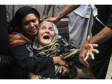 Relatives of victims mourn after a fire tore through apartment blocks mourn in Bangladesh's capital Dhaka on Feb. 21, 2019.