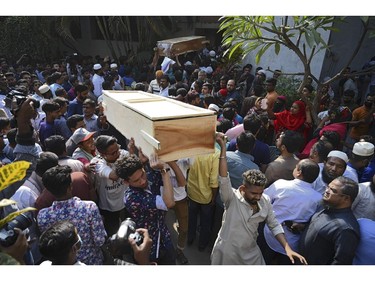 Relatives carry out coffins of fire victims from a hospital after a fire tore through apartment blocks in Bangladesh's capital Dhaka on Feb. 21, 2019.