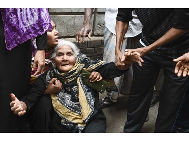 Relatives of victims mourn after a fire tore through apartment blocks in Bangladesh's capital Dhaka on Feb. 21, 2019.