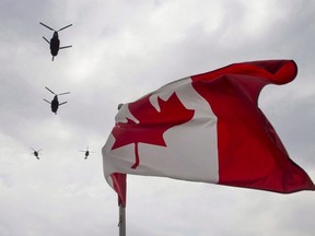 Canadian Forces CH-47 Chinooks participate in a flyover of Parliament Hill in Ottawa on Friday, May 9, 2014.