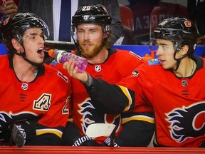 Calgary Flames Johnny Gaudreau celebrates with the purple Gatorade with teammates Sean Monahan and Elias Lindholm after scoring a power play against the San Jose Sharks in NHL hockey at the Scotiabank Saddledome in Calgary on Monday, December 31, 2018. Al Charest/Postmedia