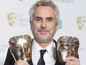 Alfonso Cuaron poses for photos after the 72nd British Academy Film Awards (BAFTAs) in London, Feb. 10, 2019.