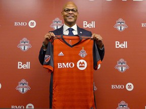 Toronto FC general manager Ali Curtis holds up a club jersey at a news conference introducing him in Toronto, Thursday, Jan.3, 2019. (THE CANADIAN PRESS/Neil Davidson)