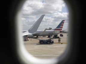 In this June 16, 2018, file photo, American Airlines aircrafts aircrafts are seen at O'Hare International Airport in Chicago. (AP Photo/Kiichiro Sato, File)