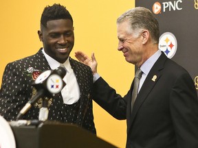 In this Feb. 28, 2017, file photo, Pittsburgh Steelers wide receiver Antonio Brown, left, smiles as he is introduced by Steelers President Art Rooney II at the team's headquarters, Tuesday, Feb. 28, 2017, in Pittsburgh. (AP Photo/Keith Srakocic, File)