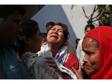 A Bangladeshi woman mourns the death of a relative in a fire, outside a morgue in Dhaka, Bangladesh, Thursday, Feb. 21, 2019.