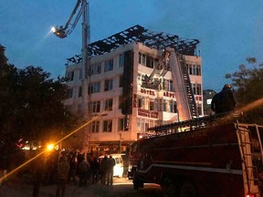 In this photo provided by Sivanand Chand, a hotel guest who was rescued, firefighters rescue people during an early morning fire at the Arpit Palace Hotel in the Karol Bagh neighbourhood of New Delhi, India, Tuesday, Feb. 12, 2019.