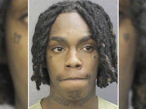 In this Wednesday, Feb. 13, 2019 photo made available by the Broward County Sheriff's Office. Fla., shows rapper YNW Melly under arrest. Police have charged Melly with killing two of his close friends who were also rising rap starts, and trying to make it appear they died in a drive-by shooting. (Broward County Sheriff's Office via AP)