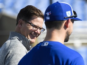 Toronto Blue Jays general manager Ross Atkins, left, laughs at baseball spring training in Dunedin, Fla., on Thursday, February 14, 2019. THE CANADIAN PRESS/Nathan Denette ORG XMIT: NSD119