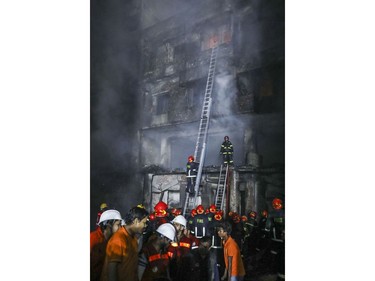 Firefighters work to douse flames in Dhaka, Bangladesh, Thursday, Feb. 21, 2019.