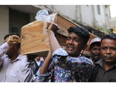 A Bangladeshi boy cries as he carries the coffin of a relative who died in a fire in Dhaka, Bangladesh, Thursday, Feb. 21, 2019.