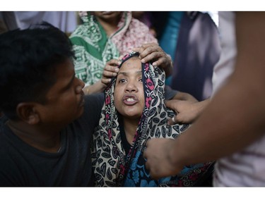 A woman mourns the death of a relative in a fire, outside a morgue in Dhaka, Bangladesh, Thursday, Feb. 21, 2019. A devastating fire raced