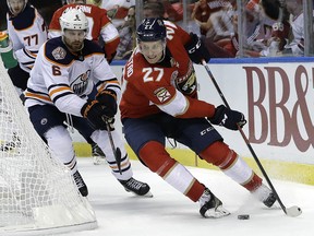 Florida Panthers centre Nick Bjugstad (27) skates with the puck as Edmonton Oilers defenceman Adam Larsson (6) defends Thursday, Nov. 8, 2018, in Sunrise, Fla. (AP Photo/Lynne Sladky)