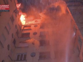 In this image taken from video released by the Paris Fire Dept., fire fills the top floors of an apartment building, Tuesday, Feb. 5, 2019, in Paris, France.
