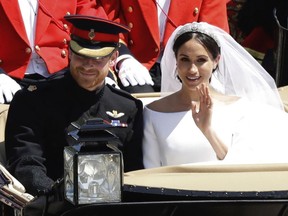 In this Saturday, May 19, 2018 file photo, Britain's Prince Harry and Meghan Markle leave Windsor Castle in a carriage after their wedding at St. George's Chapel in Windsor, near London.