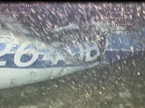 In this image released Monday Feb. 4, 2019, by the UK Air Accidents Investigation Branch (AAIB) showing the rear left side of the fuselage including part of the aircraft registration N264DB that went missing carrying soccer player Emiliano Sala, when it disappeared from radar contact on Jan. 21 2019.  The Air accident investigators say one body is visible in the sea in the wreckage of the plane that went missing carrying soccer player Emiliano Sala and his pilot David Ibbotson.