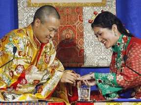 Sakyong Mipham Rinpoche, left, places a ring on his bride Princess Tseyang Palmo's finger during their Tibetan Buddhist royal wedding ceremony in Halifax on Saturday, June 10, 2006.