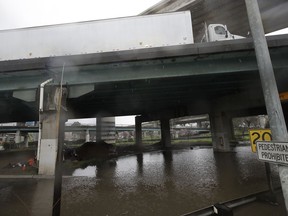 A truck drives over a flooded freeway underpass in San Francisco, Thursday, Feb. 14, 2019.