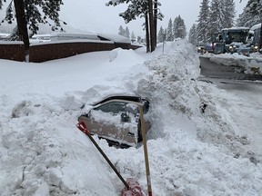 This Feb. 17, 2019 photo provided by City of South Lake Tahoe shows a car buried in snow in South Lake Tahoe, Calif. (City of South Lake Tahoe via AP)