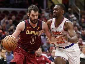 Cleveland Cavaliers' Kevin Love drives past New York Knicks' Noah Vonleh in the first half of an NBA basketball game, Monday, Feb. 11, 2019, in Cleveland.