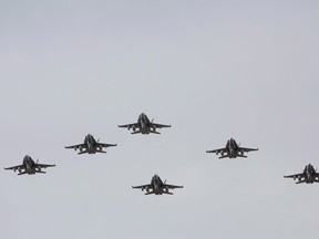 CF-18 Hornets fly in formation on their the departure for Operation IMPACT, in Cold Lake, Alberta on Tuesday Oct. 21, 2014.