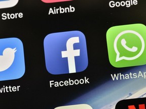 In this Thursday, Nov. 15, 2018 file photo the icon of Facebook is pictured on an iPhone in Gelsenkirchen, Germany.