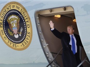 U.S. President Donald Trump waves while boarding Air Force One for a trip to Vietnam to meet with North Korean leader Kim Jong Un, Monday, Feb. 25, 2019, at Andrews Air Force Base, Md.