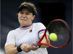 Canada's Eugenie Bouchard returns the ball to Romania's Simona Halep during a match of the Dubai Duty Free Tennis Championship in Dubai, United Arab Emirates, Tuesday, Feb. 19, 2019.