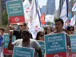 Ontario elementary teachers supporters make their way up University Ave in protest to the sex-ed rollback at Queen's Park in Toronto Aug. 14, 2018.