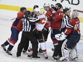 Members of the Washington Capitals and the Calgary Flames scuffle after an NHL hockey game Friday, Feb. 1, 2019, in Washington.