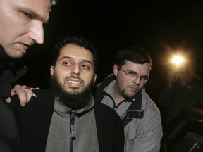 In this Friday, Nov. 17, 2006 photo Moroccan Mounir el Motassadeq, centre, is arrested by German police in front of his appartment in Hamburg, Germany.