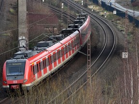 A regional train passes on the railtracks by the first five-kilometre (three-mile) stretch of a bicycle highway that is set to span over 100 km, on Dec. 24, 2015 in Mulheim an der Ruhr, western Germany. (PATRIK STOLLARZ/AFP/Getty Images)